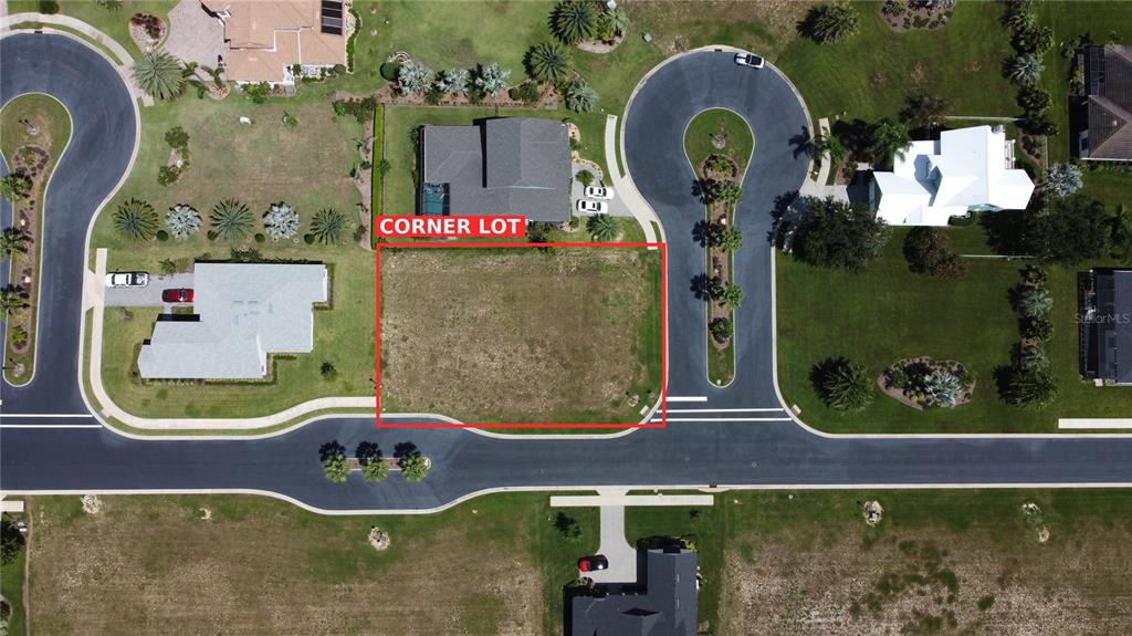 This aerial view shows a vacant, rectangular corner lot outlined in red within a residential neighborhood — 314 PULCHELLA WAY, LAKE ALFRED, FL