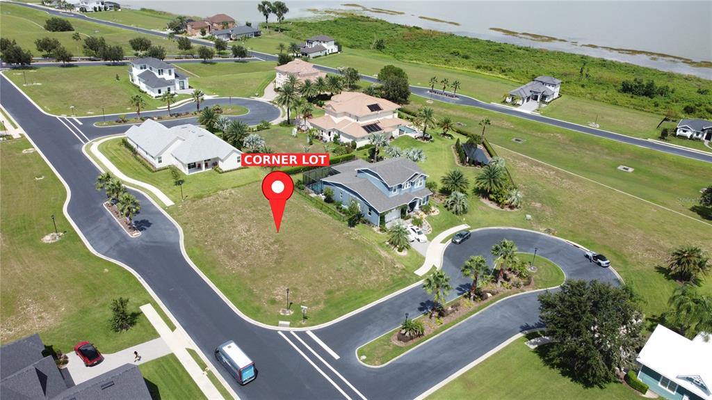 An aerial view shows a vacant corner lot situated within a suburban residential neighborhood — 314 PULCHELLA WAY, LAKE ALFRED, FL