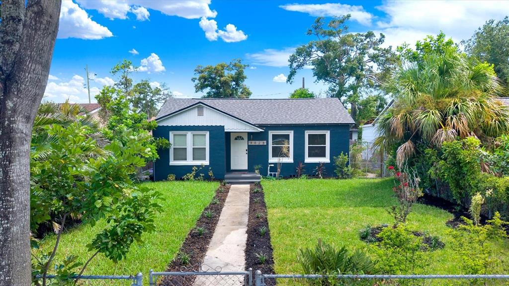 A dark blue, single-story house with a gray shingled roof and a front walkway — 4828 6TH AVENUE S, ST PETERSBURG, FL