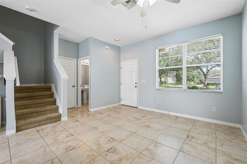 A row of residential townhomes with attached garages and parked cars in front — 12740 LANGSTAFF DRIVE, WINDERMERE, FL