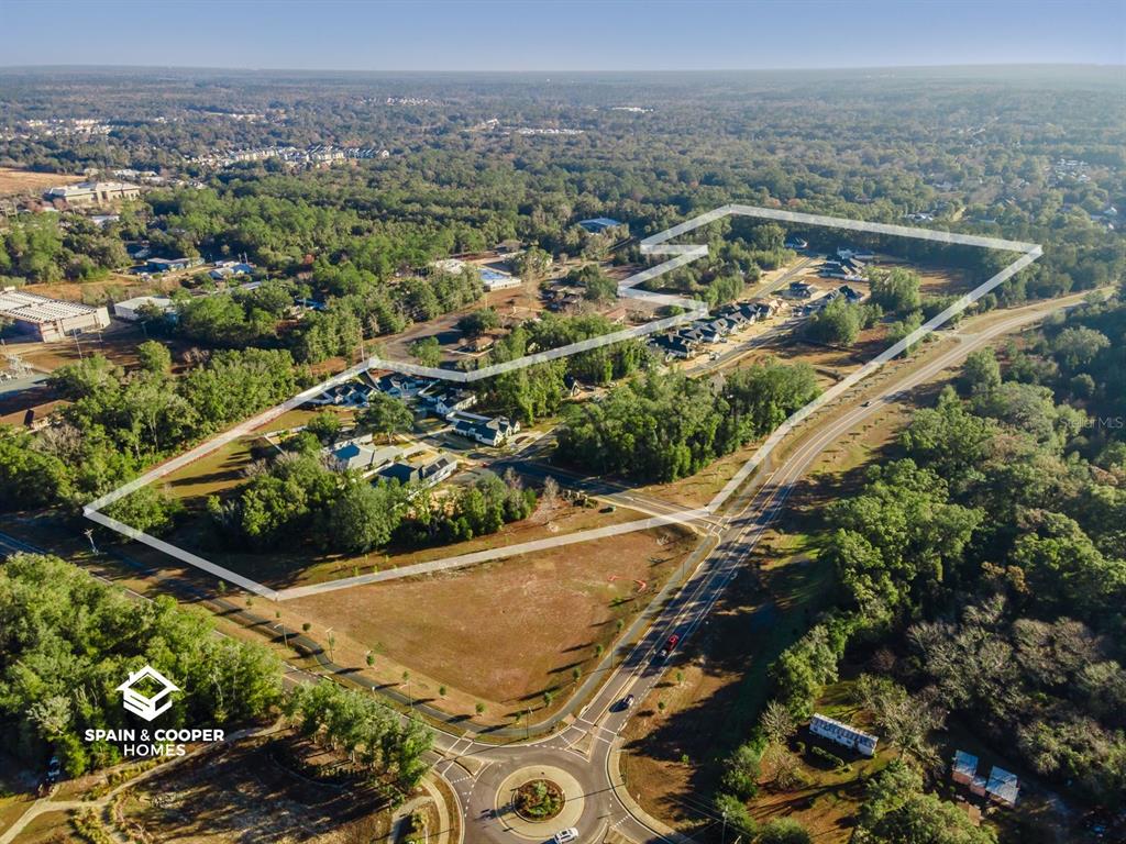 An aerial view shows a residential development outlined in white near a roundabout and forest — 14134 SW 7TH PLACE, NEWBERRY, FL