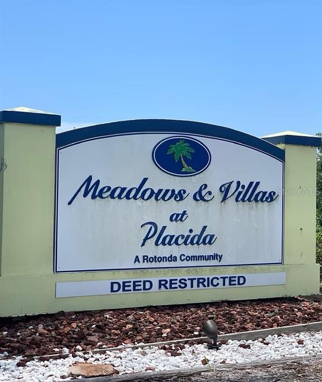 A sign for Meadows & Villas at Placida stands in front of a landscaped bed — 96 WREN DRIVE, PLACIDA, FL