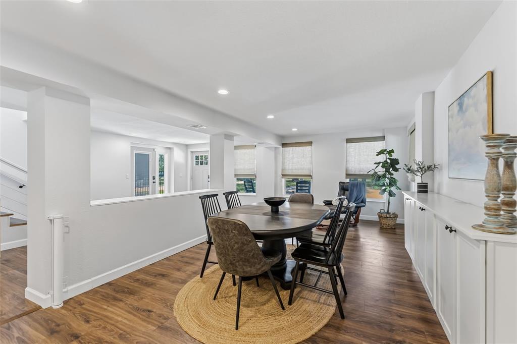 A dining room features a round wooden table, black chairs, and white built-in cabinets — 1120 1ST AVENUE N, SAFETY HARBOR, FL