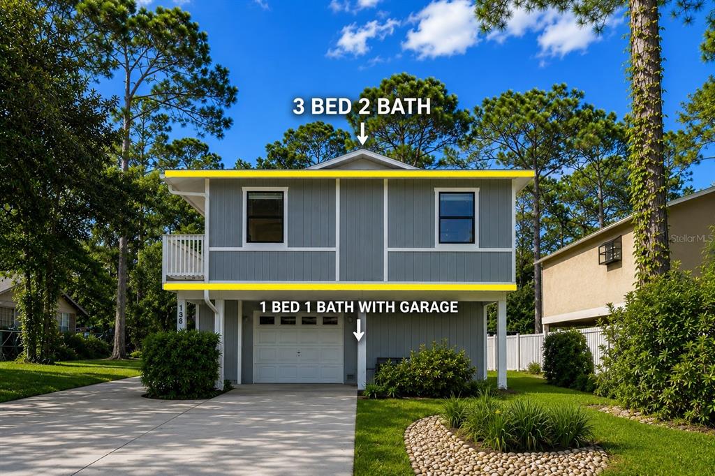 A two-story house with a garage on the ground floor and a balcony on the side — 138 69TH AVENUE N, ST PETERSBURG, FL