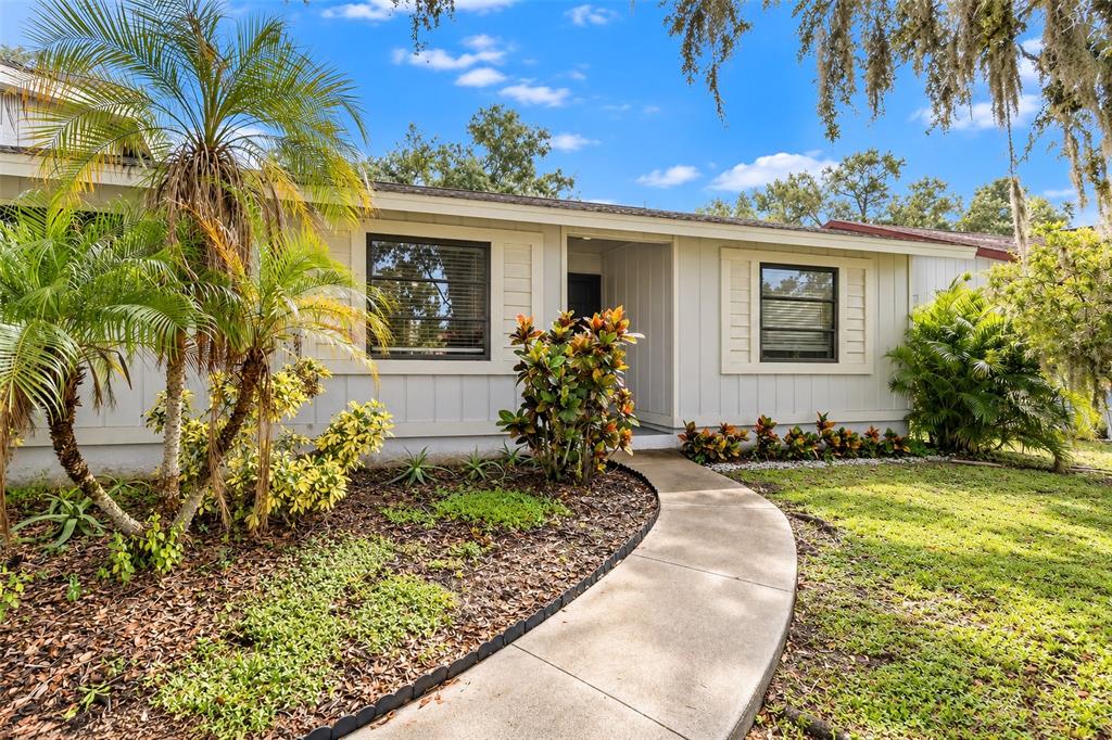 A kitchen with white cabinets, granite countertops, stainless steel appliances, and tiled flooring — 2475 WOOD OAK DRIVE, SARASOTA, FL