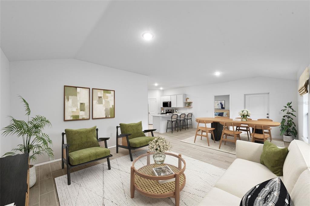 An open-concept living and dining area features light-colored tile floors, green accent chairs, and furniture — 6572 N EARLSHIRE TERRACE, CITRUS SPRINGS, FL