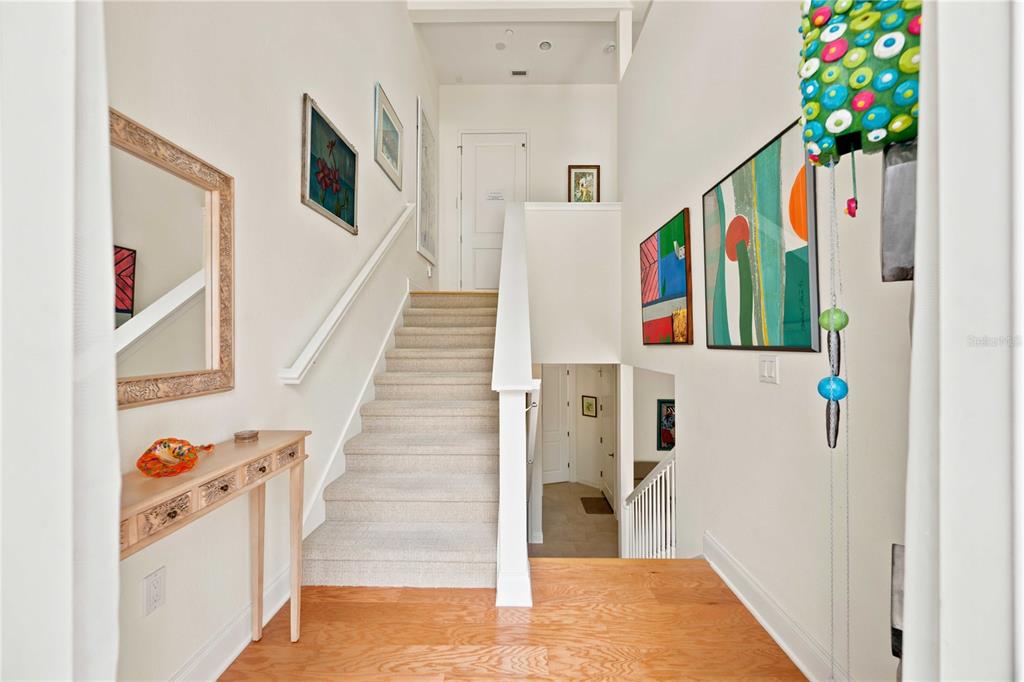 A bathroom features a double vanity with light countertops, a glass-enclosed shower, and tile flooring — 435 NOKOMIS AVENUE S UNIT 312, VENICE, FL