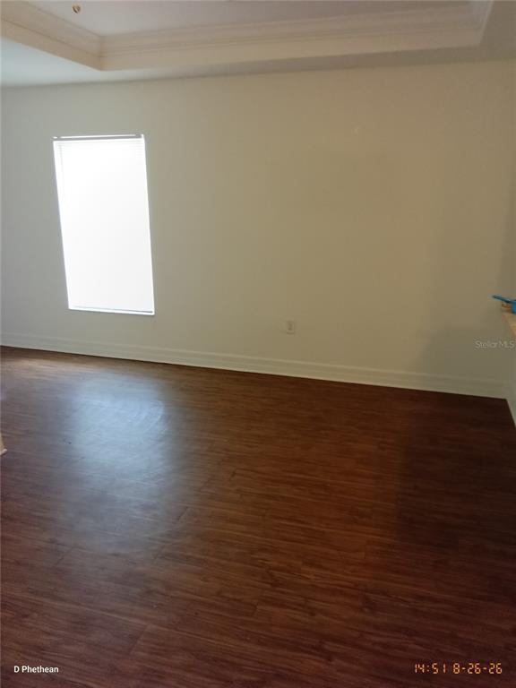 An empty room with wood-look flooring, white walls, and a single window — 3814 N GARRISON STREET UNIT B, TAMPA, FL