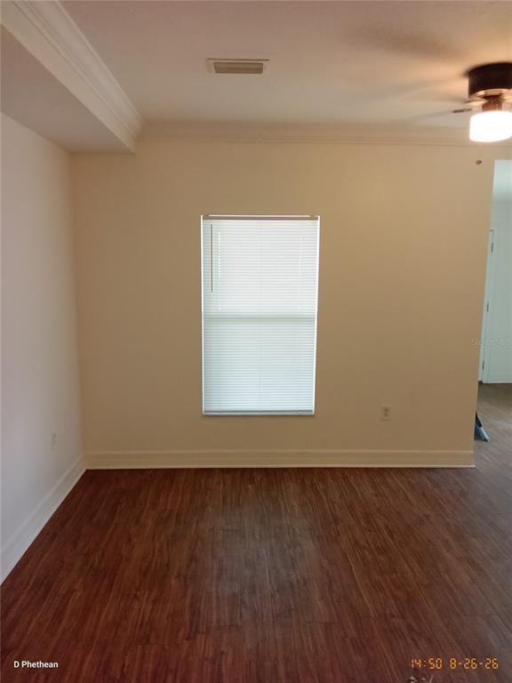 A room with wood-look flooring, a single window with blinds, and a ceiling fan — 3814 N GARRISON STREET UNIT B, TAMPA, FL