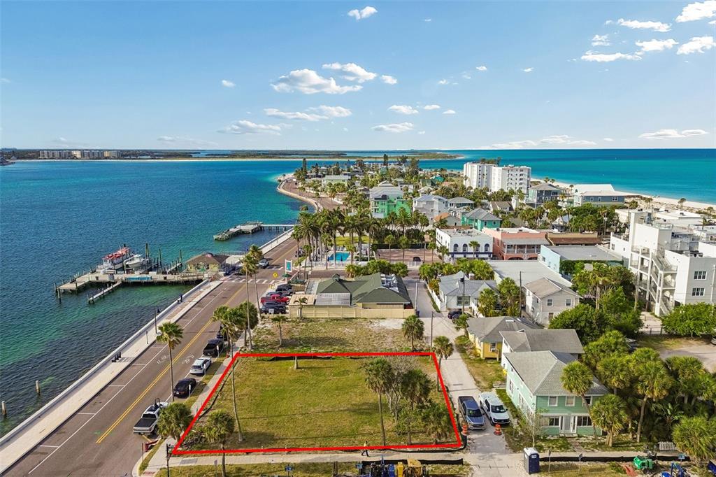 An aerial view shows a vacant rectangular lot outlined in red near a coastal road — 808 PASS A GRILLE WAY, ST PETE BEACH, FL
