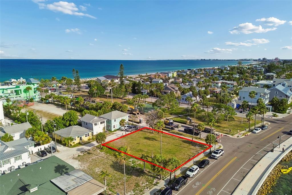 An aerial view shows a vacant, rectangular lot outlined in red near a coastal beach — 808 PASS A GRILLE WAY, ST PETE BEACH, FL