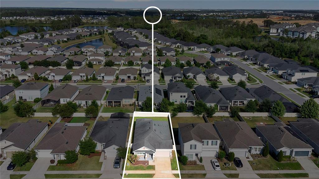 An aerial view shows a single-family house with a gray roof in a suburban neighborhood — 2920 MARLBERRY LANE, CLERMONT, FL