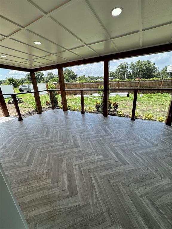 A kitchen features white upper cabinets, gray lower cabinets, stainless steel appliances, and a peninsula — 1119 N PARSONS AVENUE, SEFFNER, FL