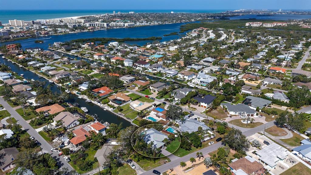 An aerial view shows a residential neighborhood with a circled house near a canal — 6136 HOLLYWOOD BOULEVARD, SARASOTA, FL