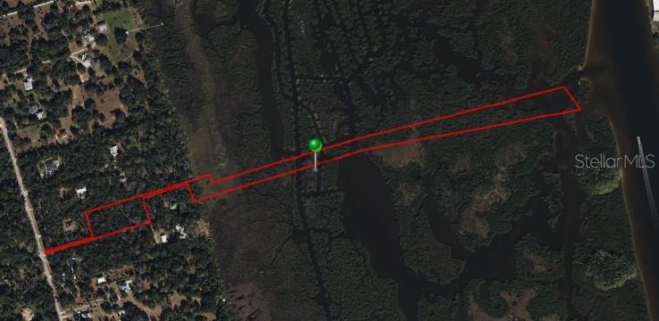 An aerial map shows a long, narrow property outlined in red extending toward the water — 5751 JOHN ANDERSON HIGHWAY, FLAGLER BEACH, FL