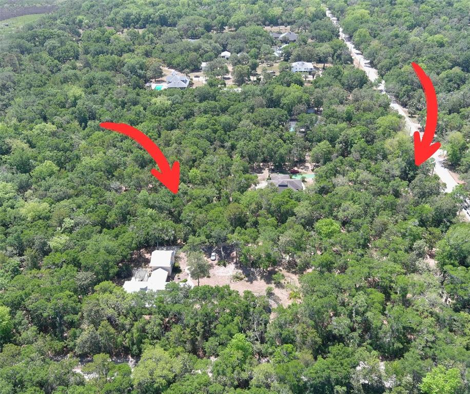 An aerial view shows a wooded residential area with houses and a paved road — 5751 JOHN ANDERSON HIGHWAY, FLAGLER BEACH, FL