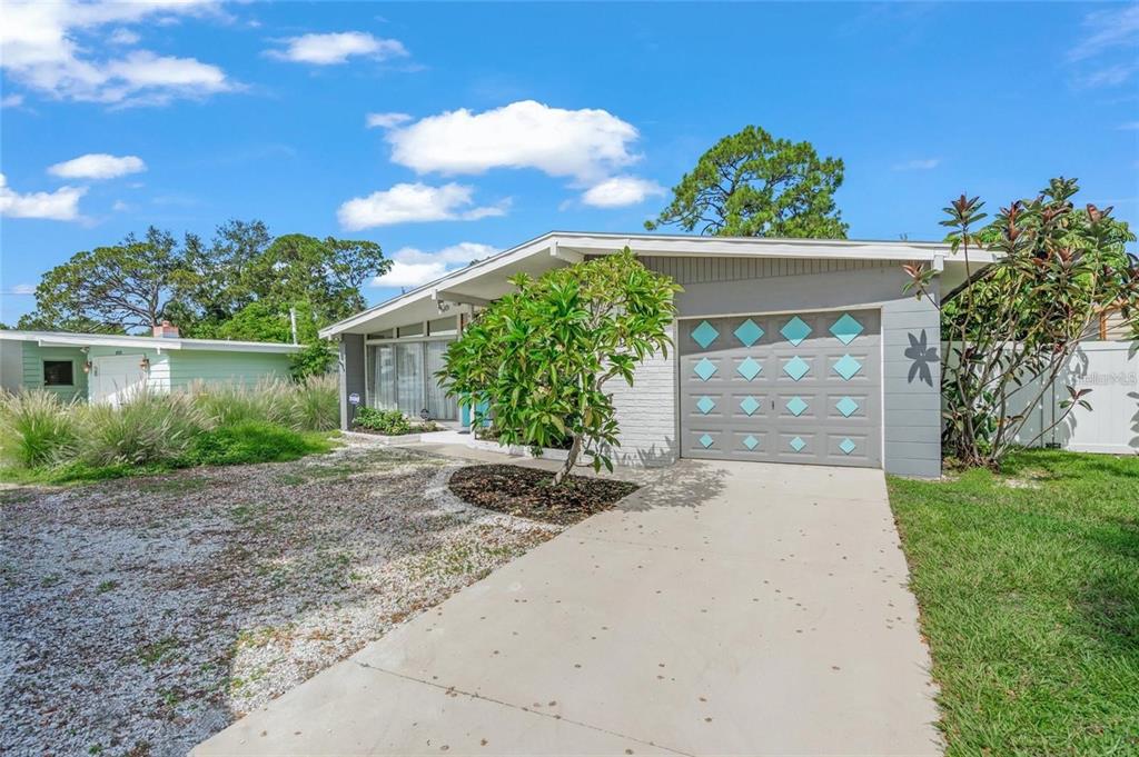 A single-story house with a gray garage door, a concrete driveway, and a front yard — 4801 SARASOTA AVENUE, SARASOTA, FL