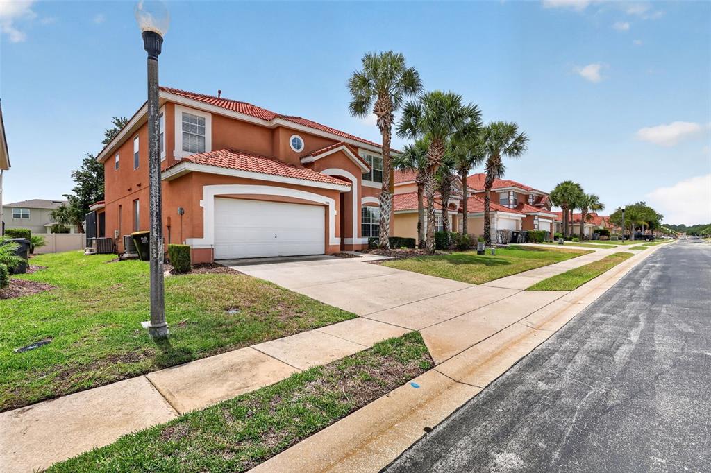 A two-story stucco house with a tile roof and a two-car garage — 928 SOLANA CIRCLE, DAVENPORT, FL