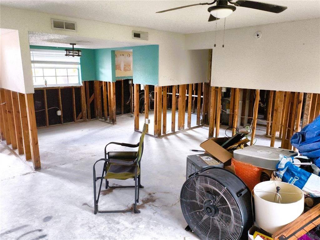 An interior room undergoing renovation with exposed wall studs and a concrete floor — 200 COUNTRY CLUB DRIVE UNIT 805, LARGO, FL