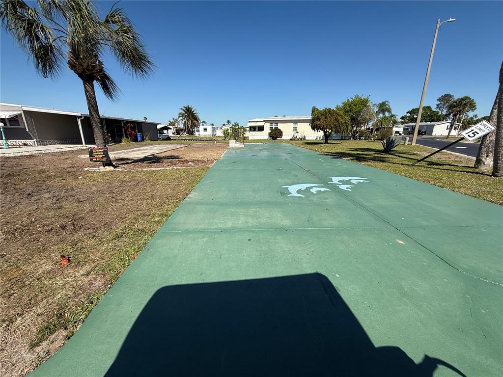 A vacant lot with a green concrete driveway and a palm tree under a clear sky — 101 E SAINT LUCIA LOOP, APOLLO BEACH, FL