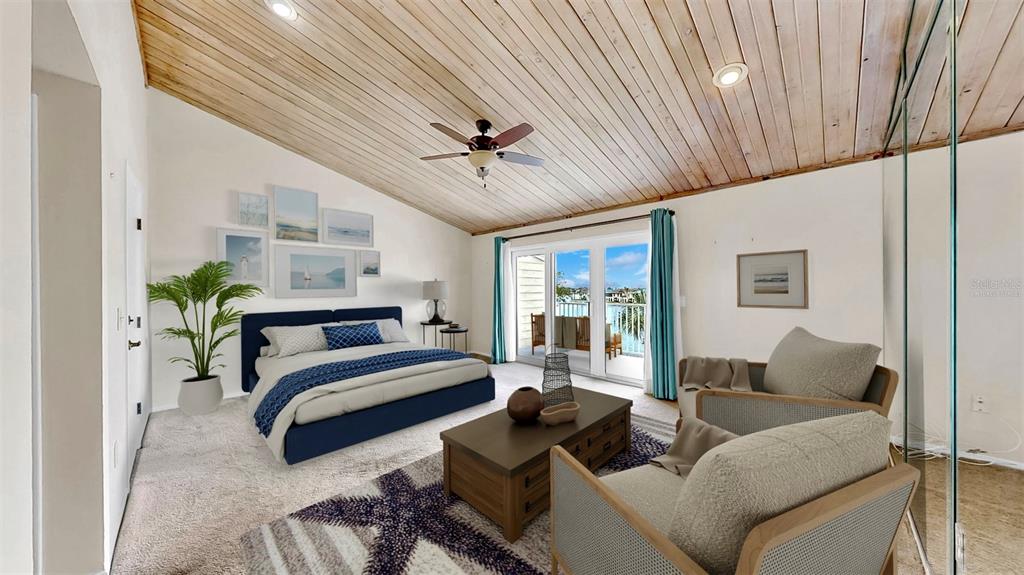 A bedroom features a vaulted wood-plank ceiling, a blue bed, and a balcony overlooking water — 459 HAVEN POINT DRIVE, TREASURE ISLAND, FL