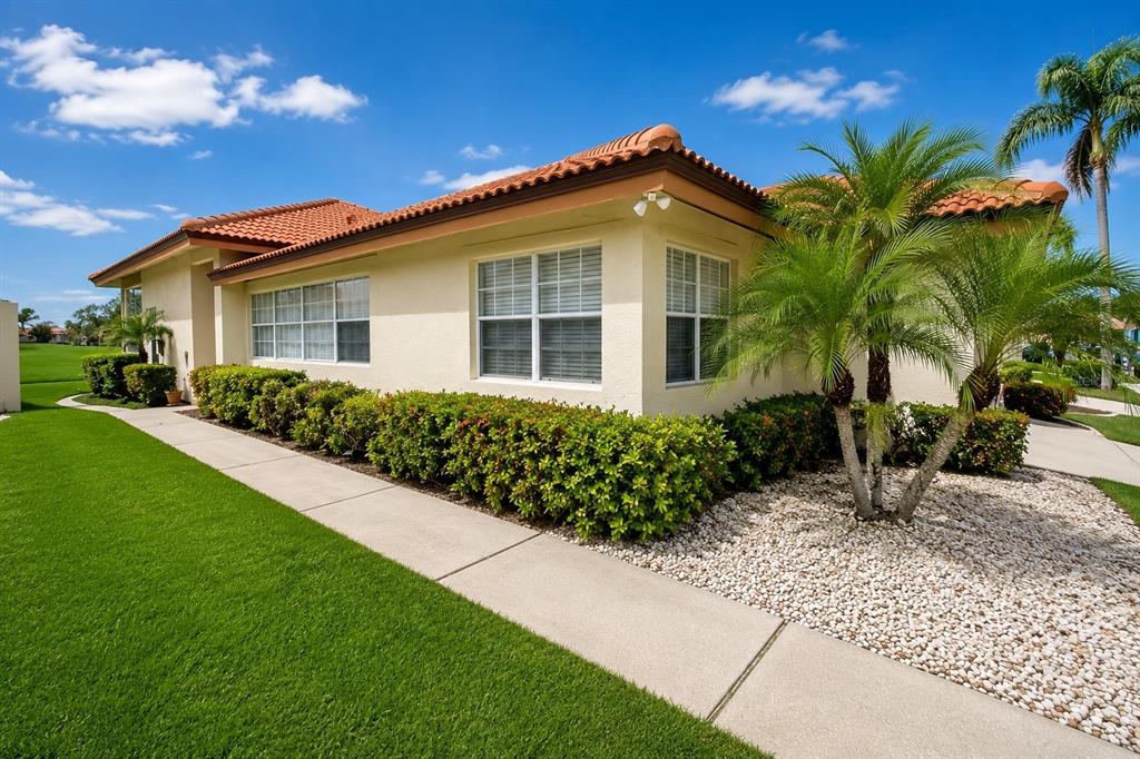 A single-story house with a tile roof, light-colored stucco walls, and a landscaped front yard — 4310 MURFIELD DRIVE E, BRADENTON, FL
