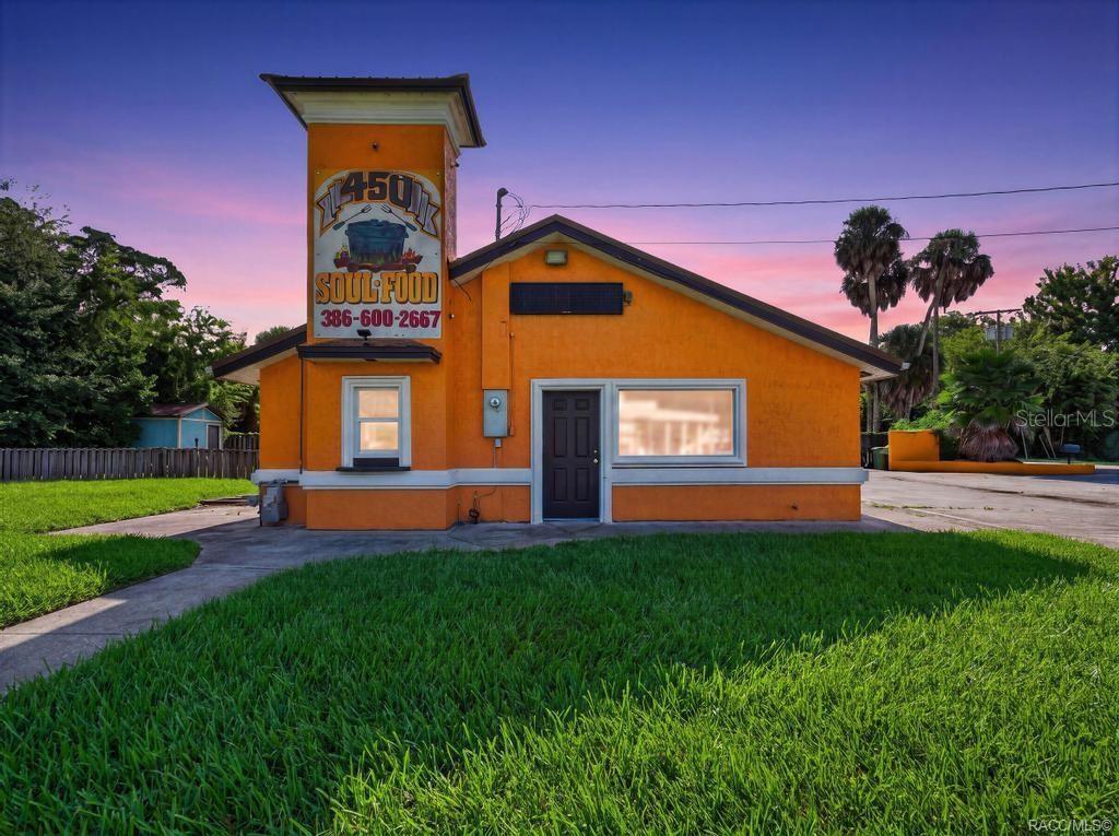 A bright orange commercial building with a prominent sign featuring a cooking pot graphic — 102 PHILLIPS DAIRY ROAD, PALATKA, FL