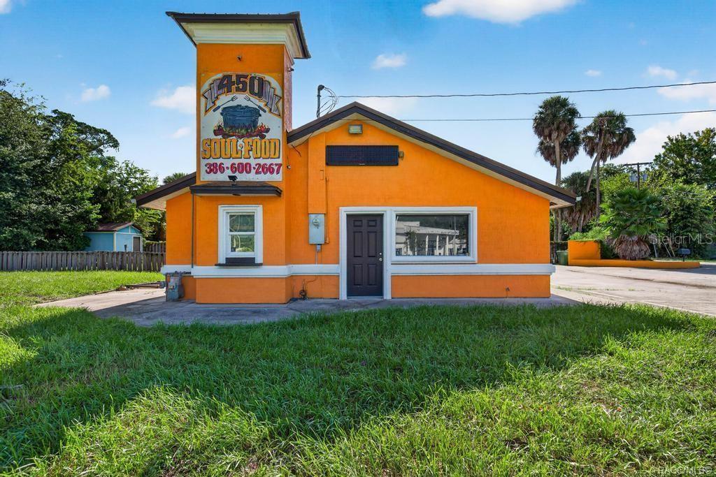 An orange, single-story commercial building with a prominent sign featuring a cooking pot graphic — 102 PHILLIPS DAIRY ROAD, PALATKA, FL