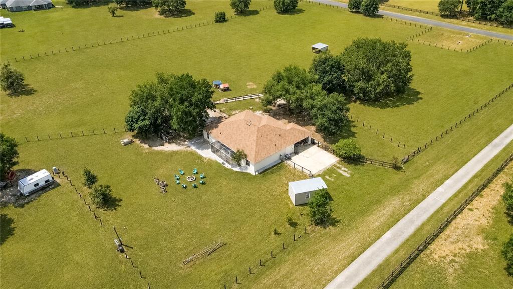 An aerial view shows a house with a tan roof, a shed, and a camper — 10525 SW 129TH TERRACE ROAD, DUNNELLON, FL