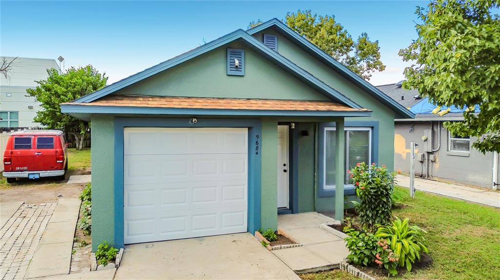 A green single-story house features a white garage door, a front entrance, and a red van — 9684 HOLLYHILL DRIVE, ORLANDO, FL
