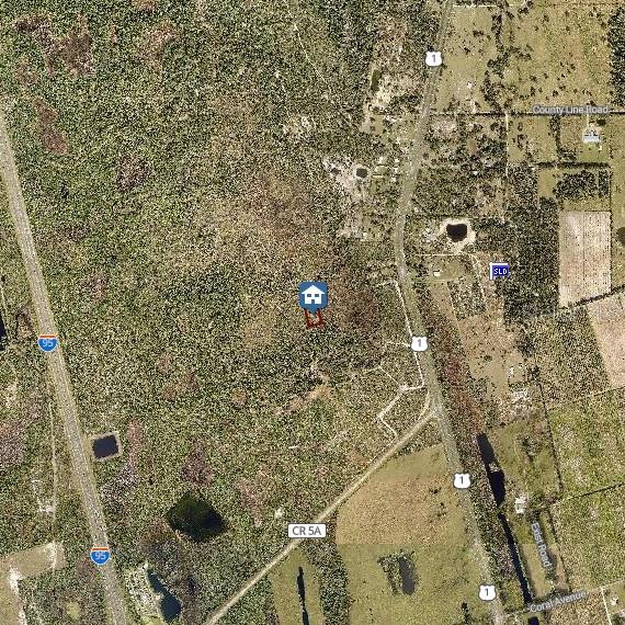 This is a satellite map showing a property lot highlighted in red near a highway — SHORT PARCEL 2003054, MIMS, FL