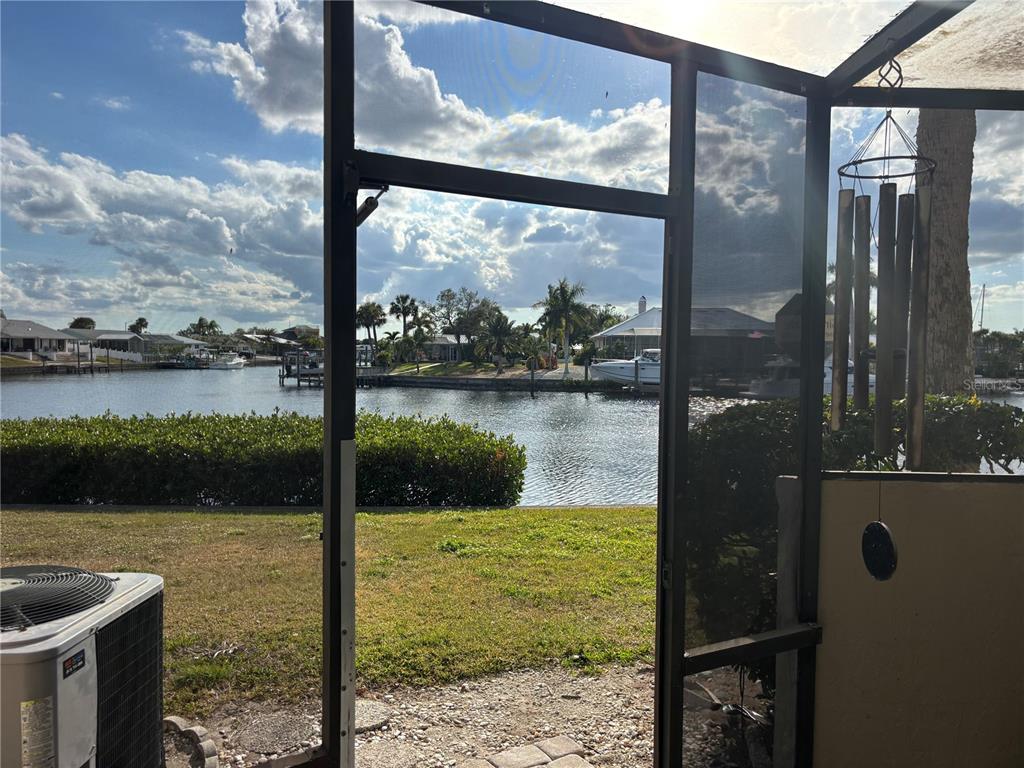 Several sailboats are docked along a wooden pier in a canal lined with palm trees — 1028 APOLLO BEACH BOULEVARD UNIT 11, APOLLO BEACH, FL