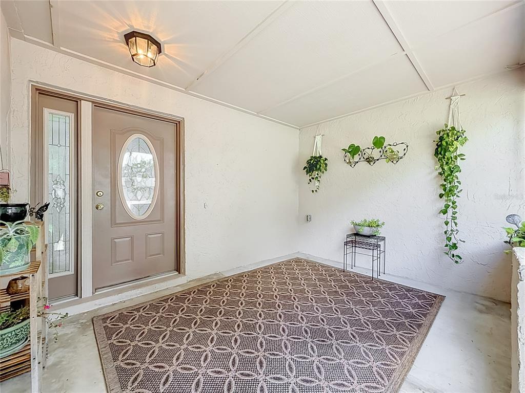A single-story house with a beige exterior, stone accents, and a two-car garage — 8654 ALEGRE CIRCLE, ORLANDO, FL