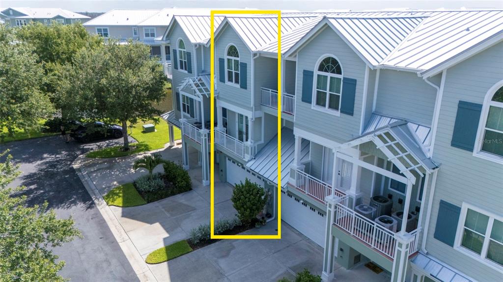 An aerial view shows the exterior of a multi-story townhouse with a highlighted entry area — 10307 CORAL LANDINGS LANE UNIT 11, PLACIDA, FL