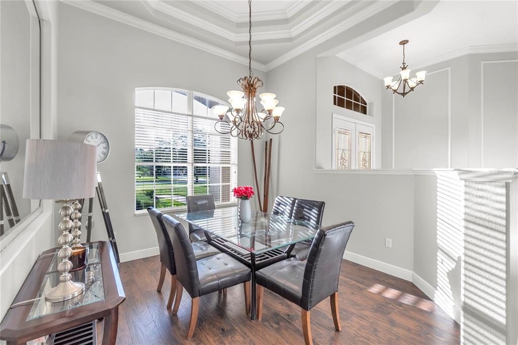A living room with a coffered ceiling, fireplace, built-in shelving, and a central half wall — 15425 29TH LANE E, PARRISH, FL