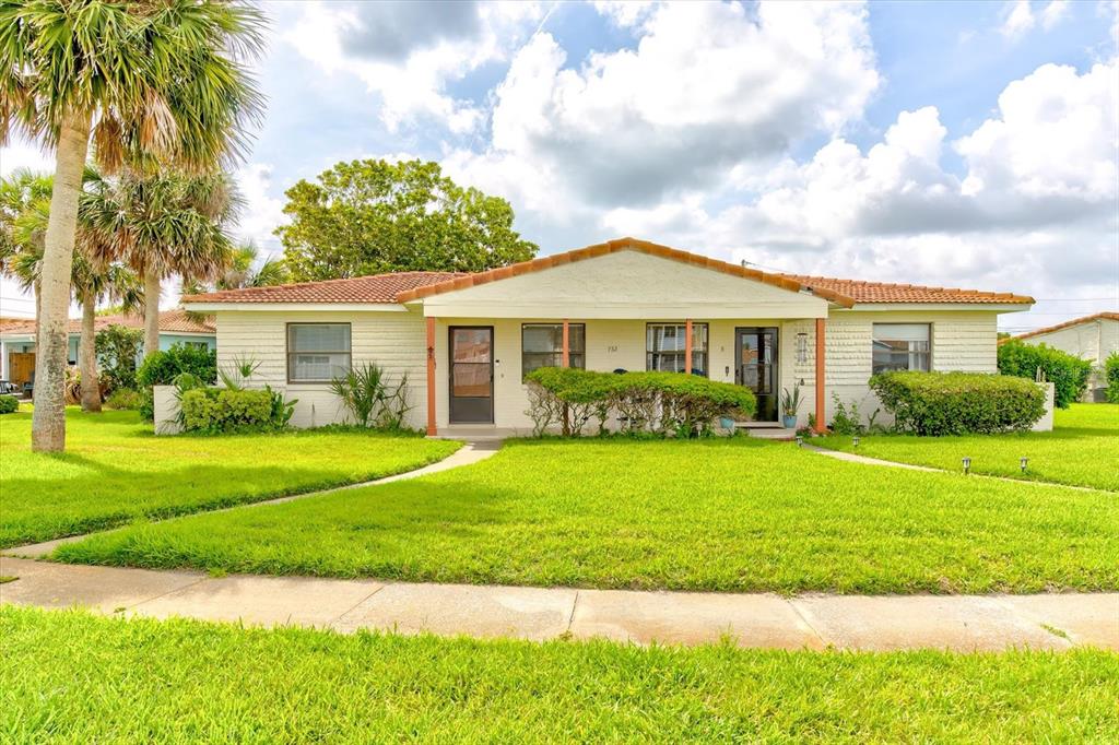 A single-story house with a light-colored exterior, a tiled roof, and a front lawn — 232 NORTHSHORE DRIVE UNIT A & #B, ORMOND BEACH, FL