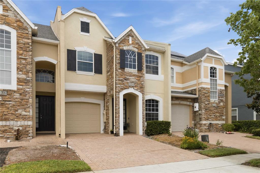 A brick entrance monument with a sign reading Woodland Terrace stands among trees and landscaping — 534 TERRACE SPRING DRIVE, ORLANDO, FL