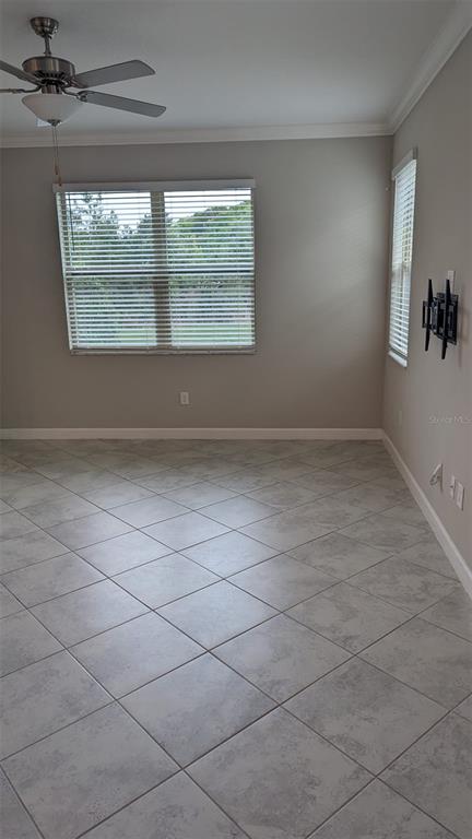A room with light-colored tile flooring, a ceiling fan, and two windows with blinds — 1384 WHITE FOX RUN, LUTZ, FL