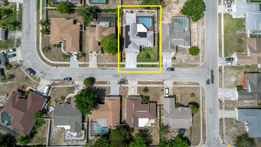 An aerial view shows a residential house with a pool and solar panels — 8112 GOLDEN BEAR LOOP, PORT RICHEY, FL