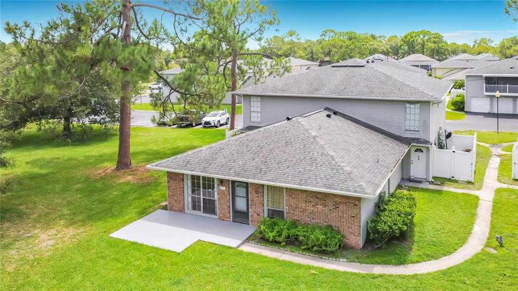 An aerial view of a two-story brick and gray siding townhouse with a concrete patio — 4375 SHADOW CREST PLACE UNIT 34-1, ORLANDO, FL