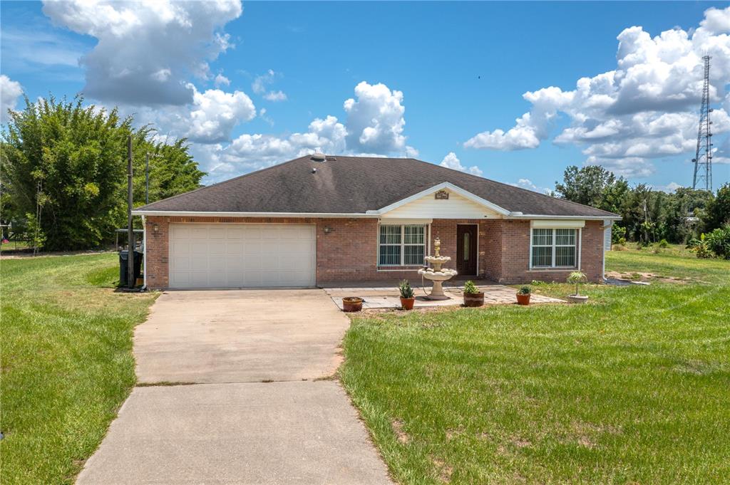 A single-story brick house with a two-car garage, a front patio, and a water fountain — 270 KEEN ROAD, FROSTPROOF, FL