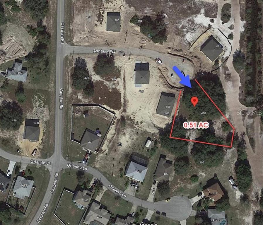 This aerial map shows a vacant, wooded residential lot highlighted in red — 410 ASHBURY WAY, KISSIMMEE, FL