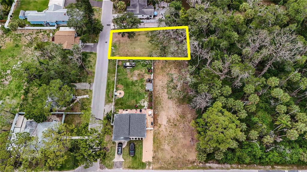 An aerial view shows a rectangular residential lot outlined in yellow next to a house — 0 LIMESTONE, PORT RICHEY, FL