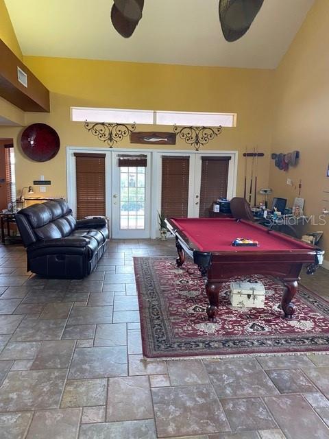 A game room features a pool table, a leather recliner, and tile flooring — 936 ALLEGRO LANE, APOLLO BEACH, FL
