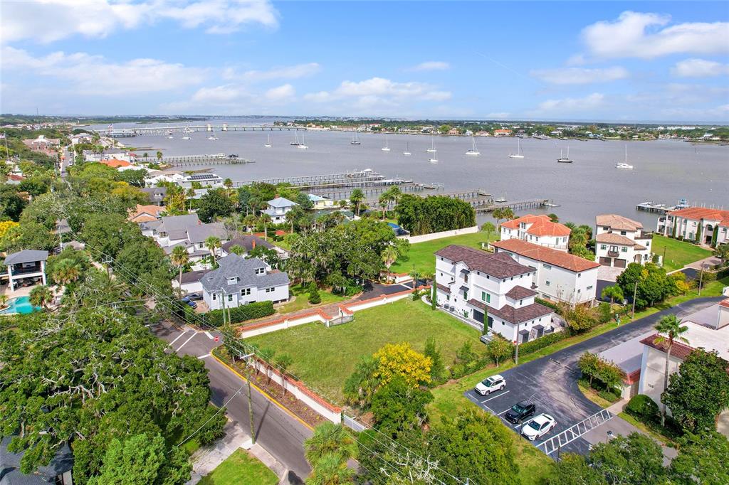 An aerial view shows a waterfront property with a large house, lawn, and parking area — 1 SOUTH STREET UNIT A & B, ST AUGUSTINE, FL