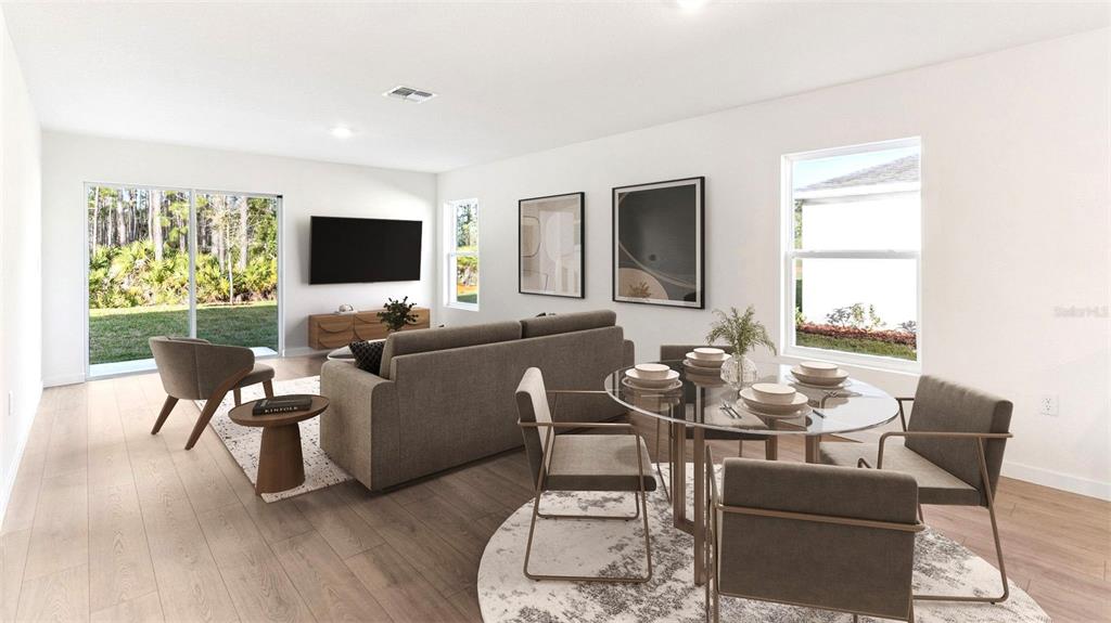 This is a digital rendering of an open-concept living and dining area with modern furniture — 133 HEIRLOOM DRIVE, ORMOND BEACH, FL