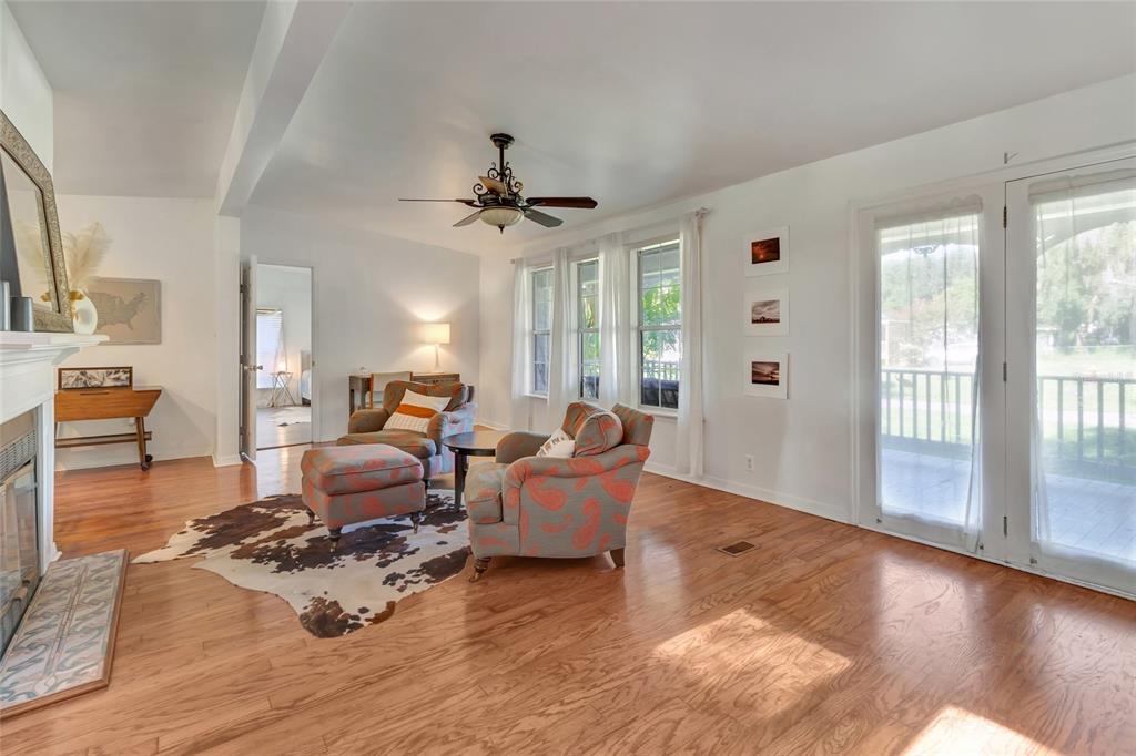 A dining room with a wooden table, chairs, hardwood floors, and a skylight ceiling — 20361 1ST STREET, MC INTOSH, FL