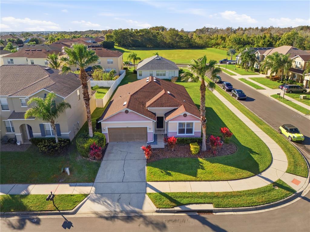 An aerial view of a pink single-story house with a two-car garage and palm trees — 502 FIRST CAPE CORAL DR, WINTER GARDEN, FL