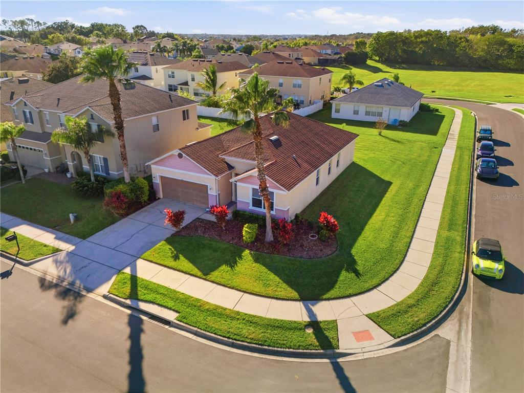 An aerial view shows a suburban house with a brown roof and a corner lot — 502 FIRST CAPE CORAL DR, WINTER GARDEN, FL