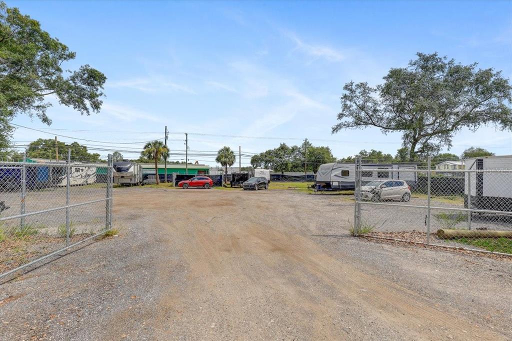 A gravel lot enclosed by a chain-link fence contains several parked vehicles and trailers — 11309 E 92 HIGHWAY, SEFFNER, FL